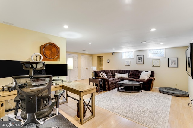 living room with recessed lighting, visible vents, light wood-style flooring, and stairs