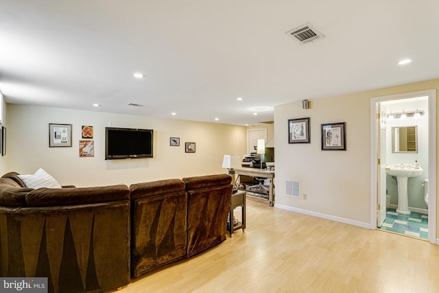 living area featuring recessed lighting, visible vents, and light wood-style flooring