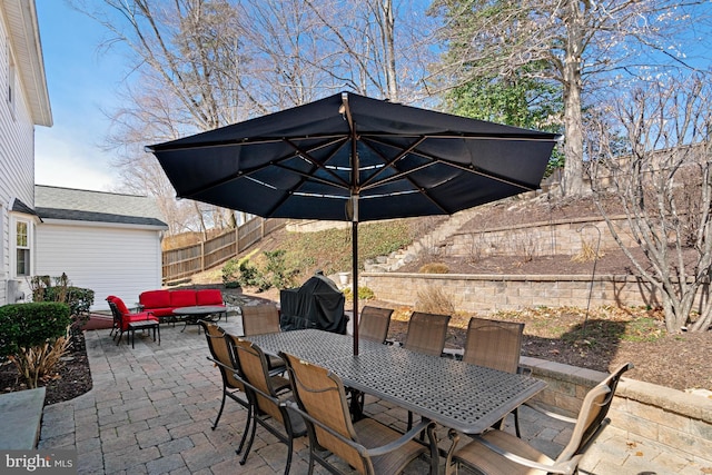 view of patio with outdoor dining space, an outdoor hangout area, and a fenced backyard