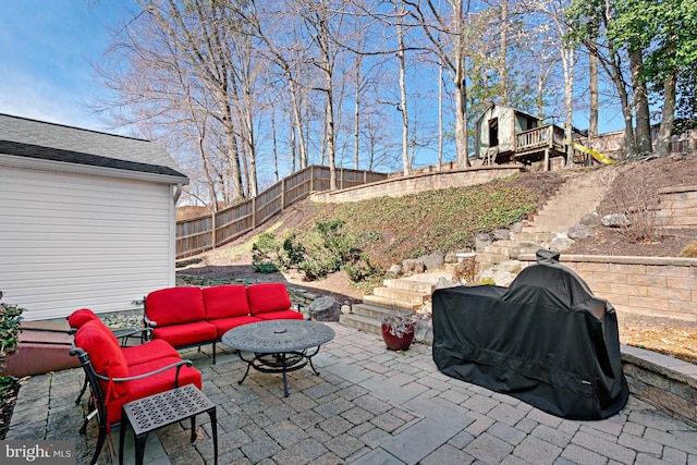 view of patio featuring stairway, an outdoor hangout area, area for grilling, and a fenced backyard