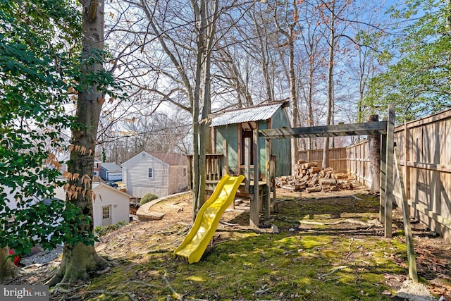 view of yard featuring a playground and fence