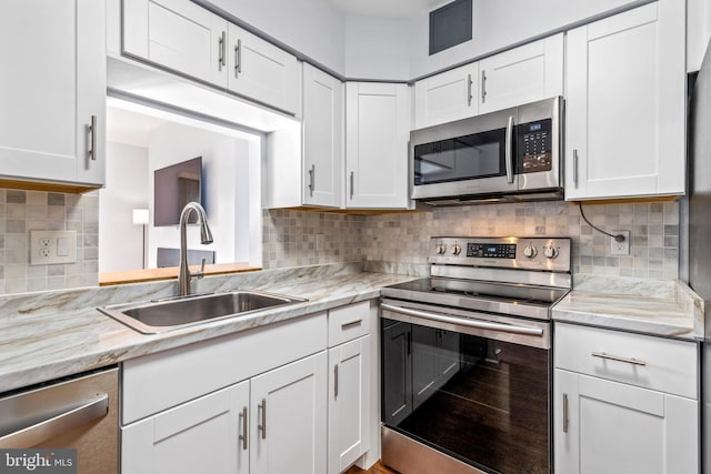 kitchen featuring a sink, appliances with stainless steel finishes, and white cabinetry