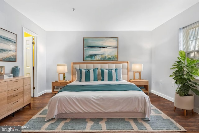 bedroom featuring dark wood-type flooring and baseboards