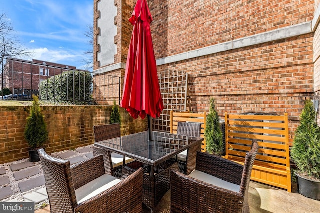 view of patio with a trampoline and outdoor dining space