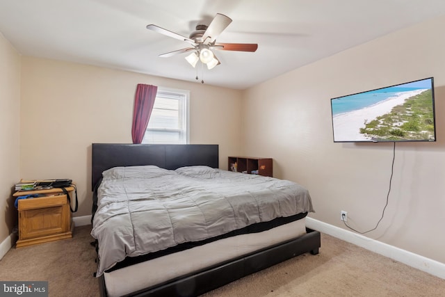 carpeted bedroom with a ceiling fan and baseboards