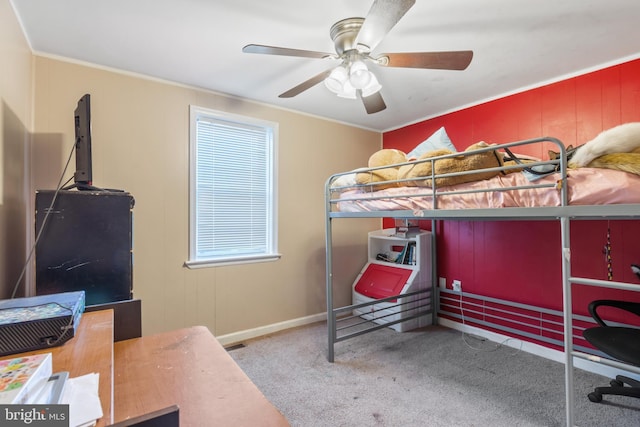 bedroom featuring a ceiling fan, carpet floors, and ornamental molding