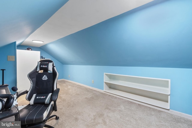 workout area featuring carpet flooring, baseboards, and vaulted ceiling