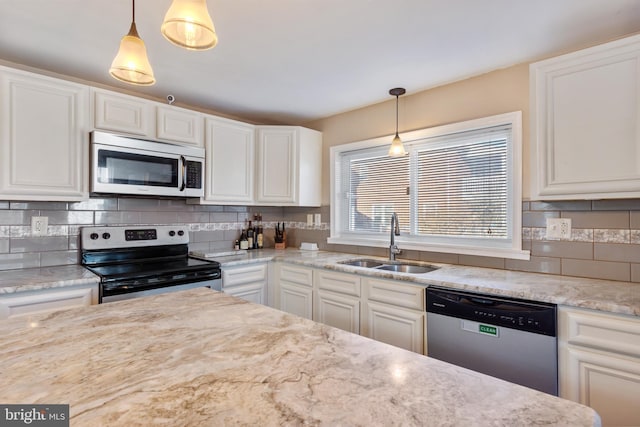 kitchen featuring a sink, white cabinetry, backsplash, and stainless steel appliances