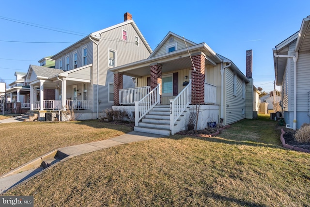 view of front of property with covered porch and a front lawn