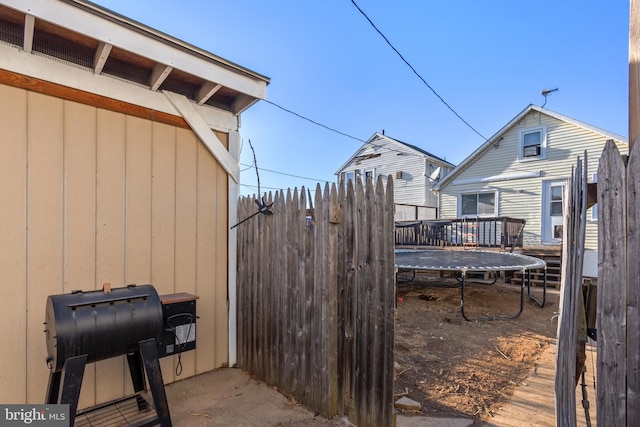 view of yard with a deck and fence