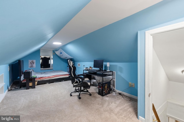 carpeted bedroom featuring lofted ceiling and baseboards