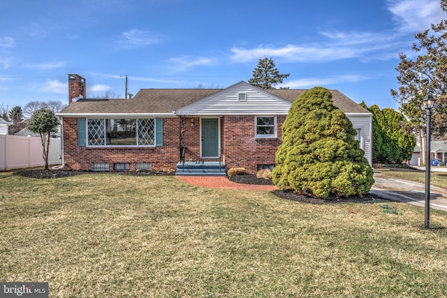 view of front facade featuring a front lawn, fence, roof with shingles, brick siding, and a chimney