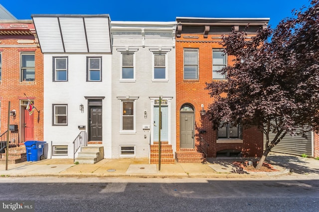 townhome / multi-family property with brick siding and entry steps