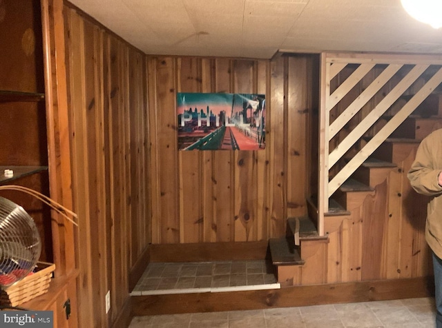 staircase with wood walls