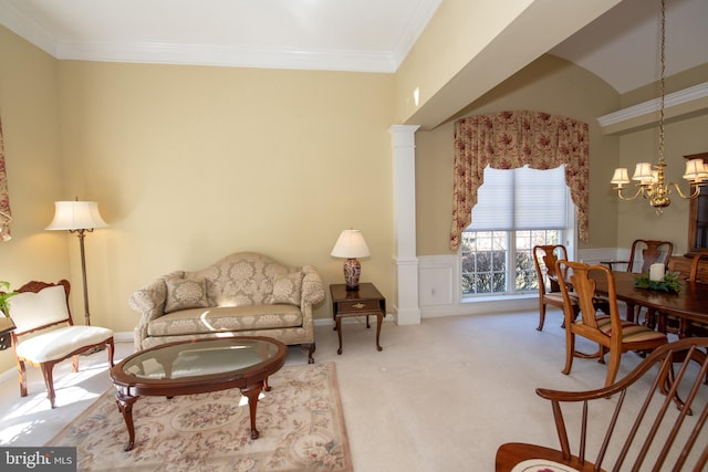 living area with carpet floors, ornamental molding, decorative columns, wainscoting, and a notable chandelier