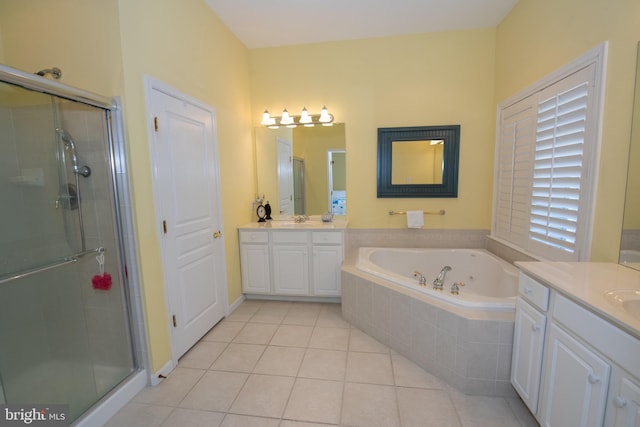 full bathroom with tile patterned floors, a garden tub, two vanities, a sink, and a shower stall