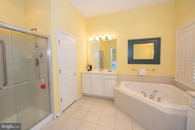 bathroom with tile patterned floors, a jetted tub, a stall shower, and vanity