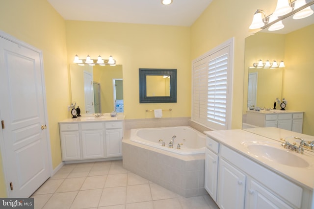 bathroom featuring tile patterned flooring, a bath, two vanities, and a sink