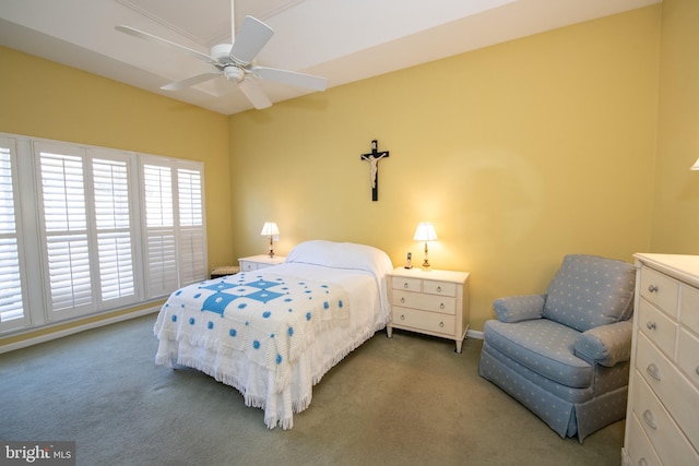 carpeted bedroom with a ceiling fan and baseboards