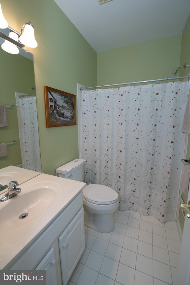 bathroom featuring tile patterned floors, a shower with curtain, toilet, and vanity