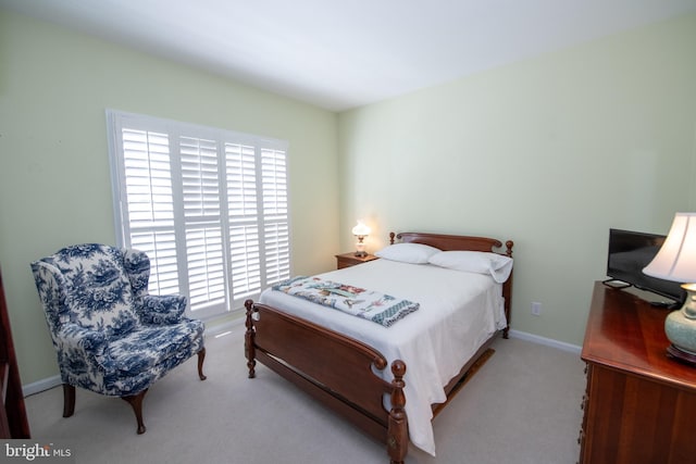 carpeted bedroom featuring baseboards