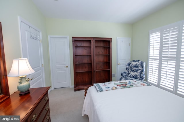 bedroom featuring light carpet