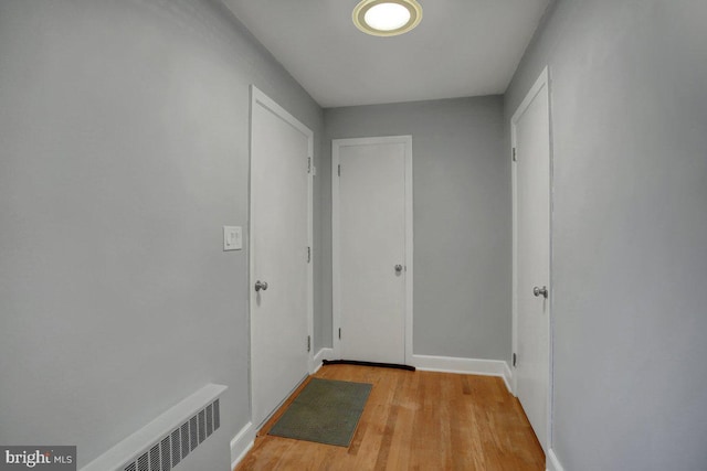 hallway with baseboards and light wood finished floors