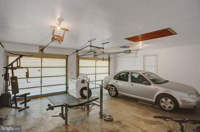 garage with washer / clothes dryer and a garage door opener