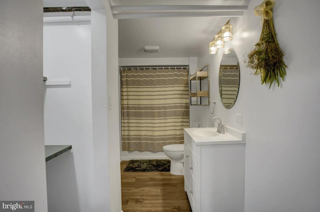 full bathroom with vanity, a shower with curtain, toilet, and wood finished floors