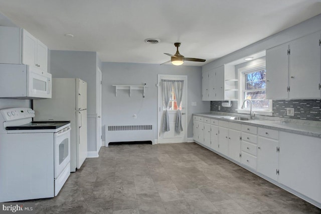 kitchen with a sink, radiator, white cabinets, white appliances, and open shelves