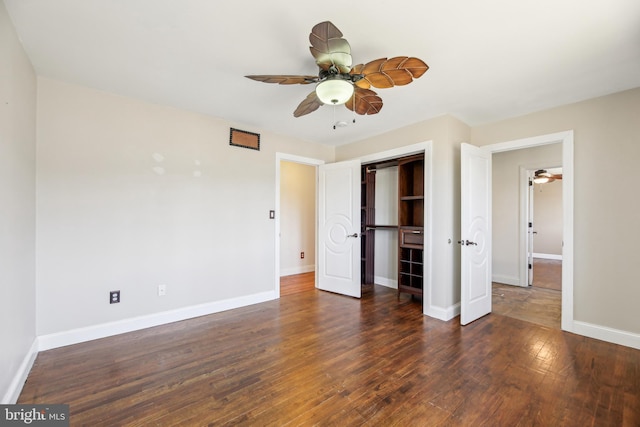 unfurnished bedroom featuring hardwood / wood-style floors, baseboards, a closet, and ceiling fan