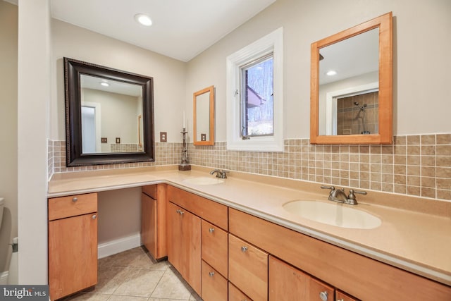 bathroom featuring tile patterned flooring, double vanity, tasteful backsplash, and a sink