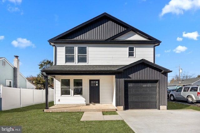 view of front facade featuring board and batten siding, a front yard, a garage, and fence