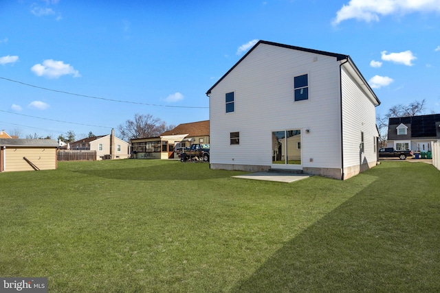 rear view of house with a patio area and a lawn