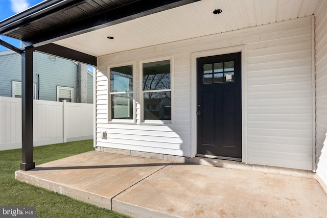 doorway to property featuring fence