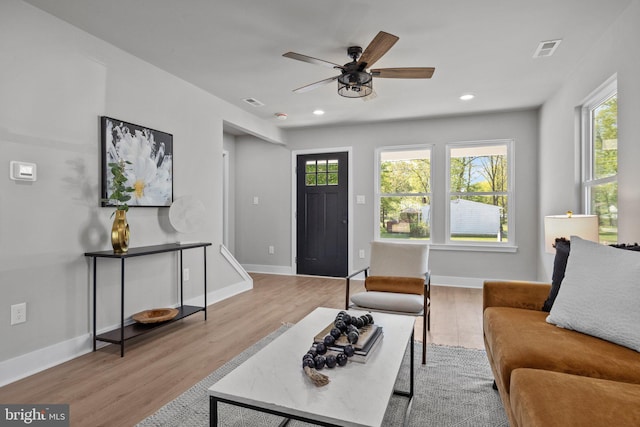 living room featuring visible vents, recessed lighting, baseboards, and wood finished floors