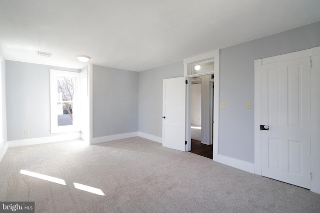 unfurnished bedroom with visible vents, baseboards, and carpet flooring