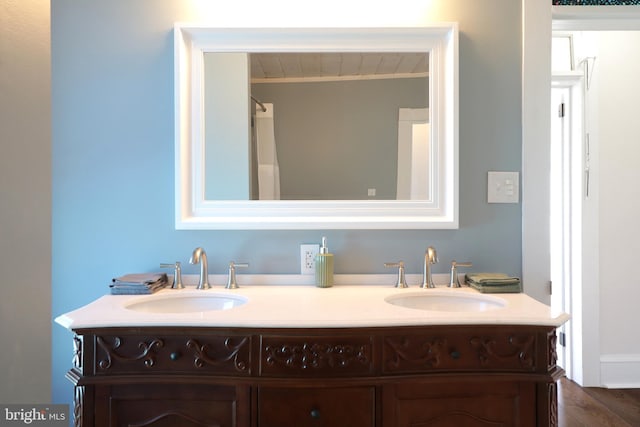 bathroom with a sink and double vanity