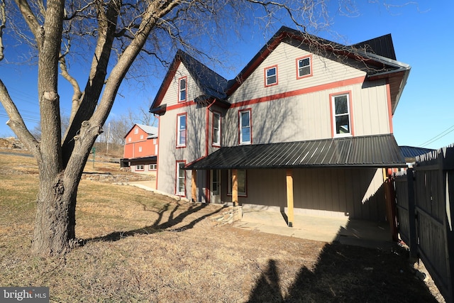 rear view of property with fence