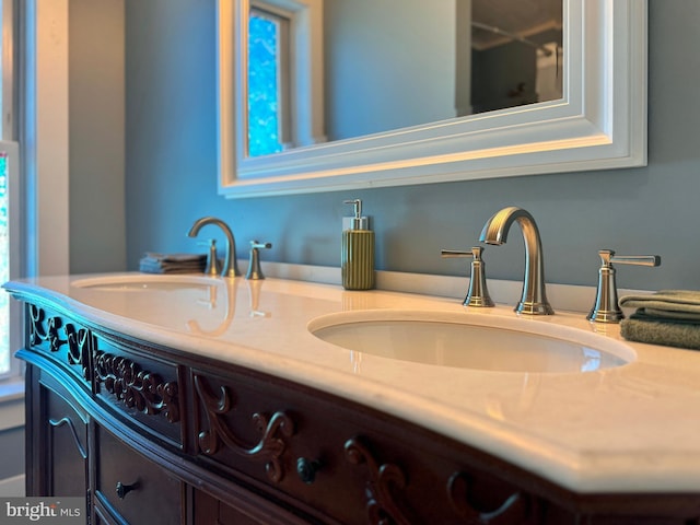 full bathroom featuring a sink and double vanity