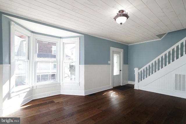 foyer entrance with stairway, wood finished floors, visible vents, wainscoting, and wooden ceiling