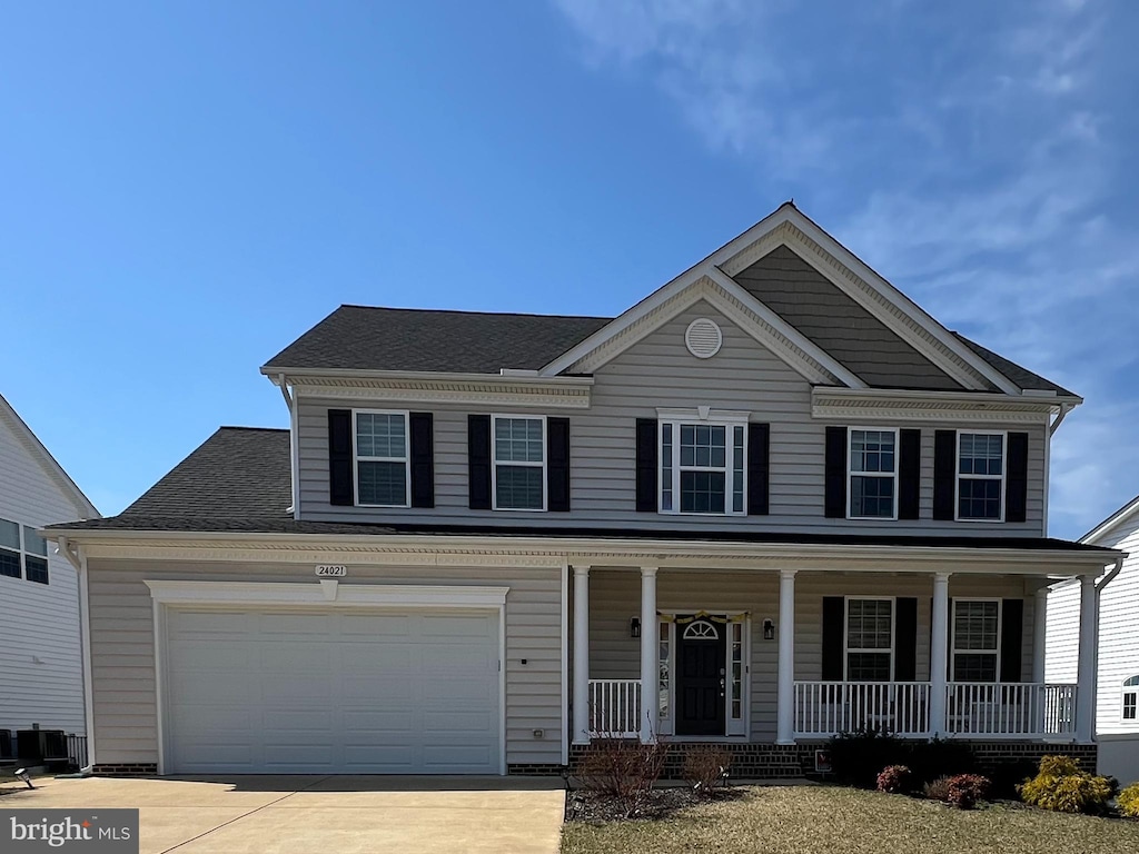 view of front of house featuring a porch and concrete driveway