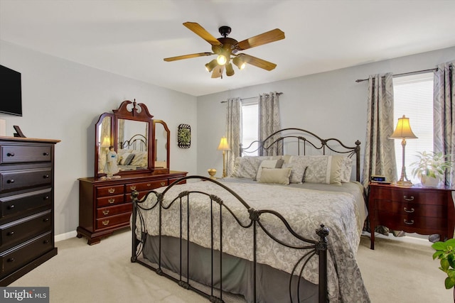 bedroom featuring ceiling fan, baseboards, and light carpet