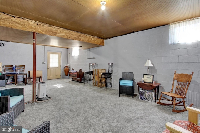 basement featuring concrete block wall and carpet flooring