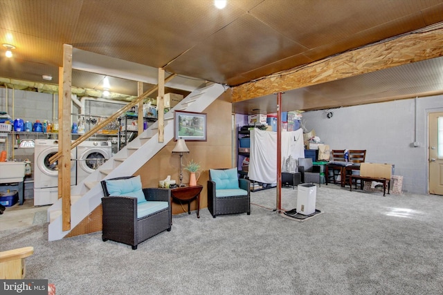 finished basement featuring washer and dryer, stairway, carpet, and a sink