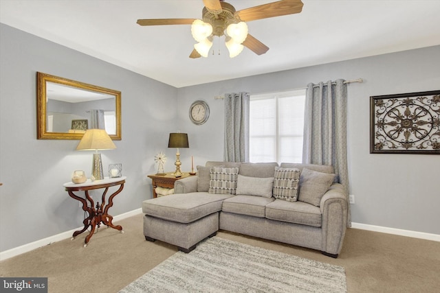 living room with a ceiling fan, carpet, and baseboards