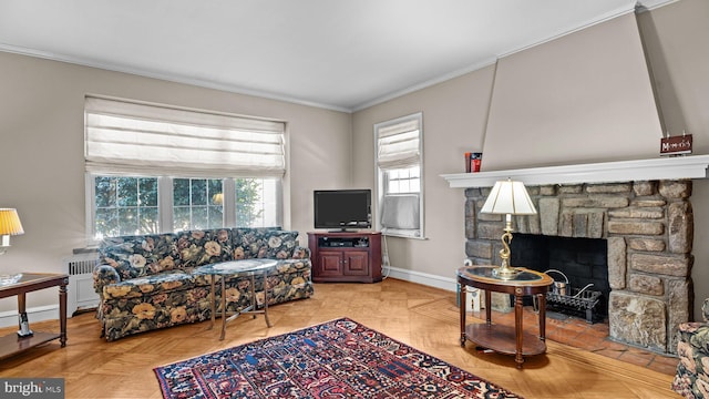 living room with baseboards, a fireplace, and crown molding