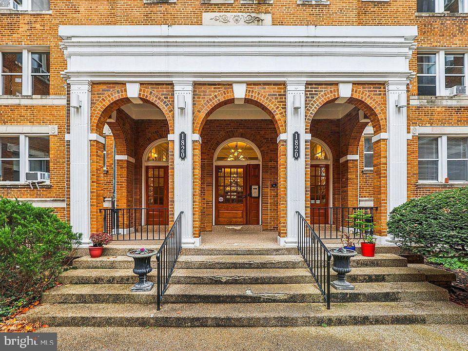 property entrance featuring brick siding