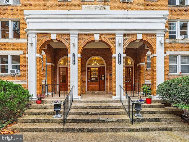 property entrance featuring brick siding