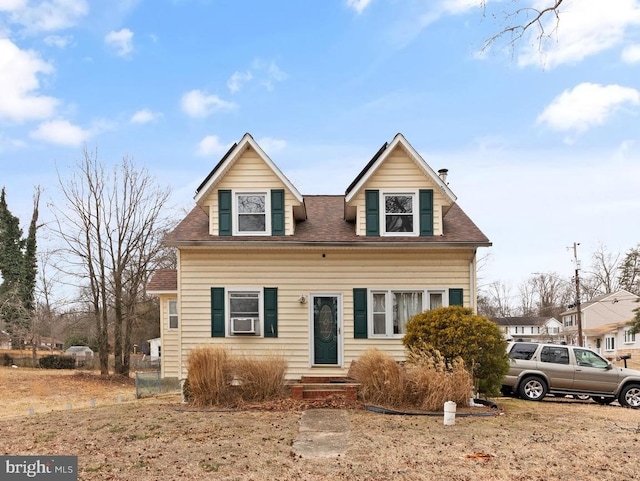 view of front of house featuring a shingled roof and entry steps